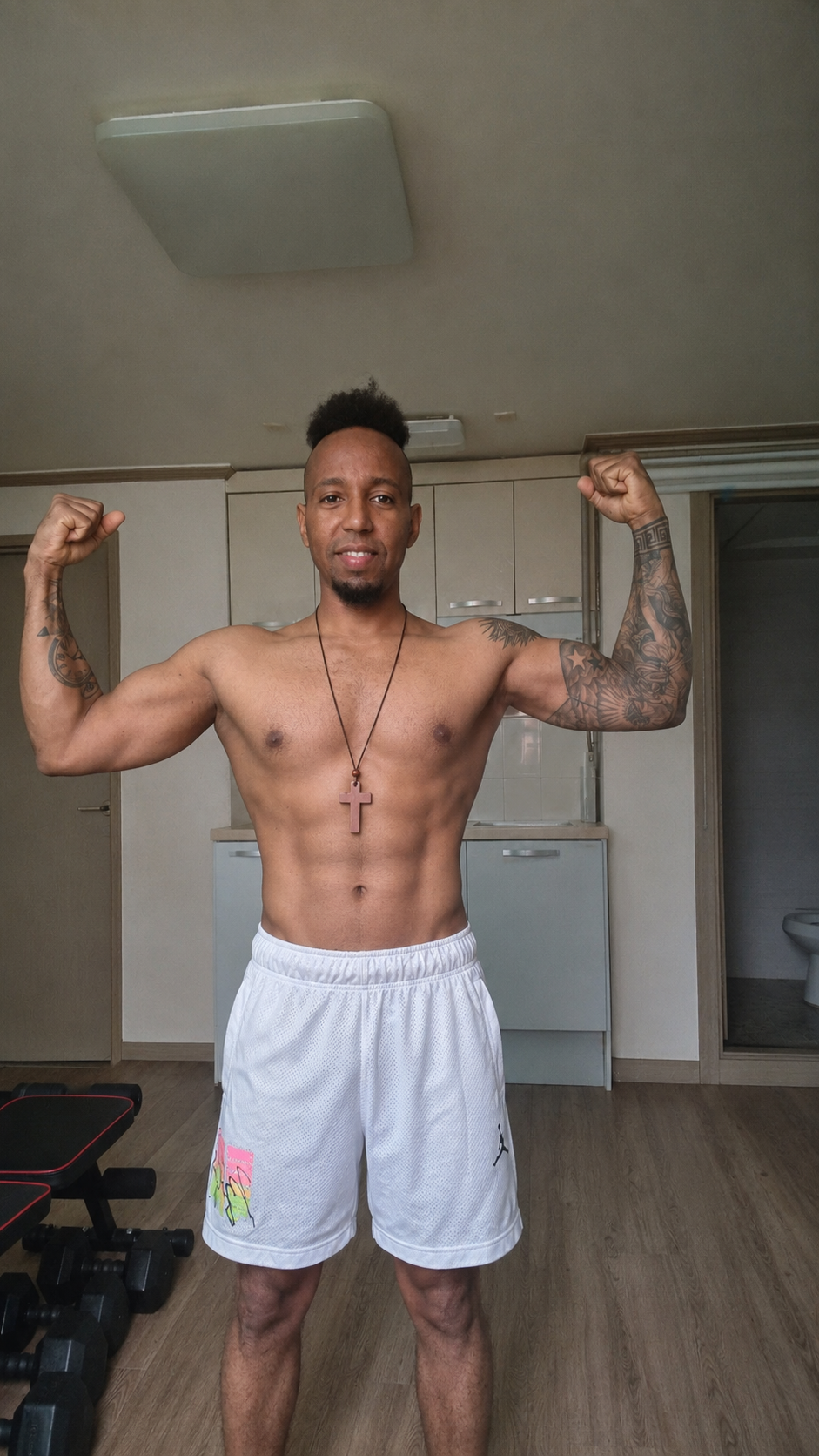AYE Fit Hub training photo — double bicep flex showing strength progress