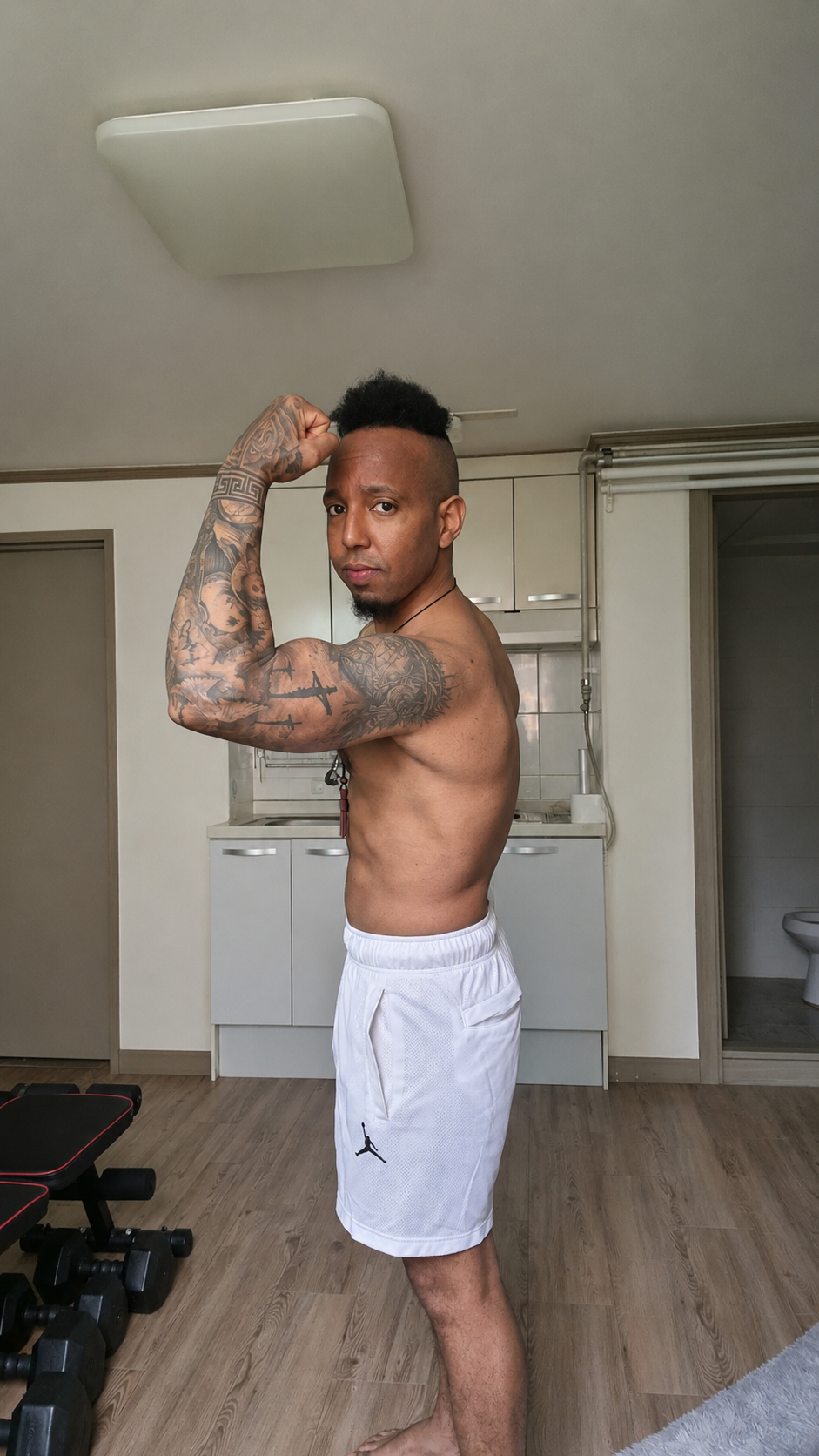 AYE Fit Hub training photo — side bicep flex pose
